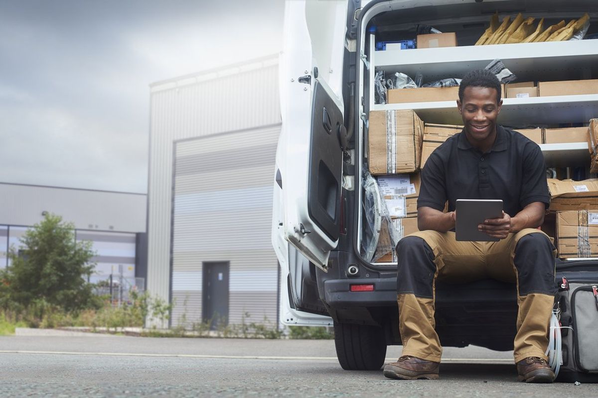 Service engineer sat at the back of his van stock photo