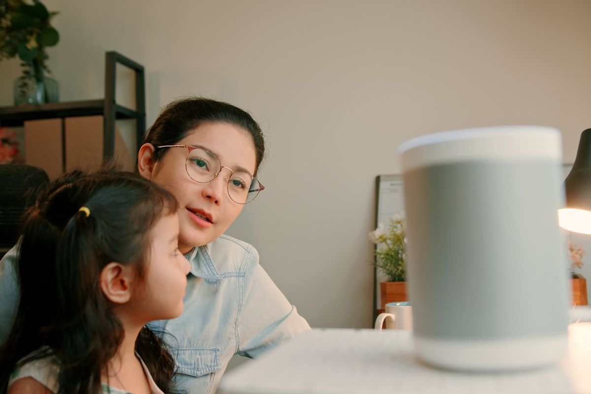 Asian Mother and Daughter Bonding While Working from Home stock photo