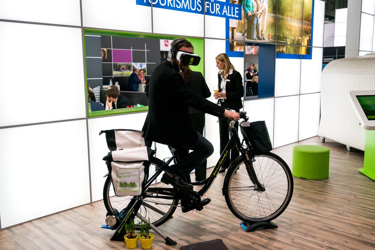 a photo of a man on a bike wearing VR headset
