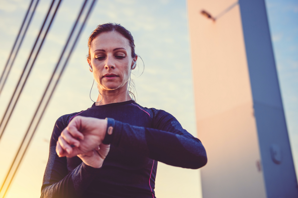 Woman checking her fitness tracker after a workout.
